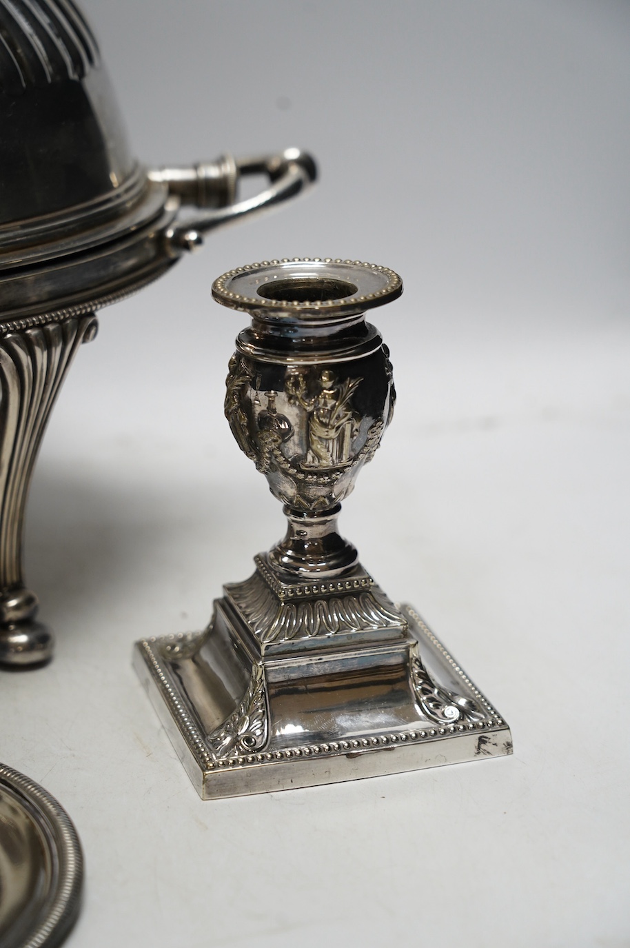 An Edwardian plated breakfast dish and sundry plated wares to include four pairs of candlesticks / chamber sticks. Condition - fair to good